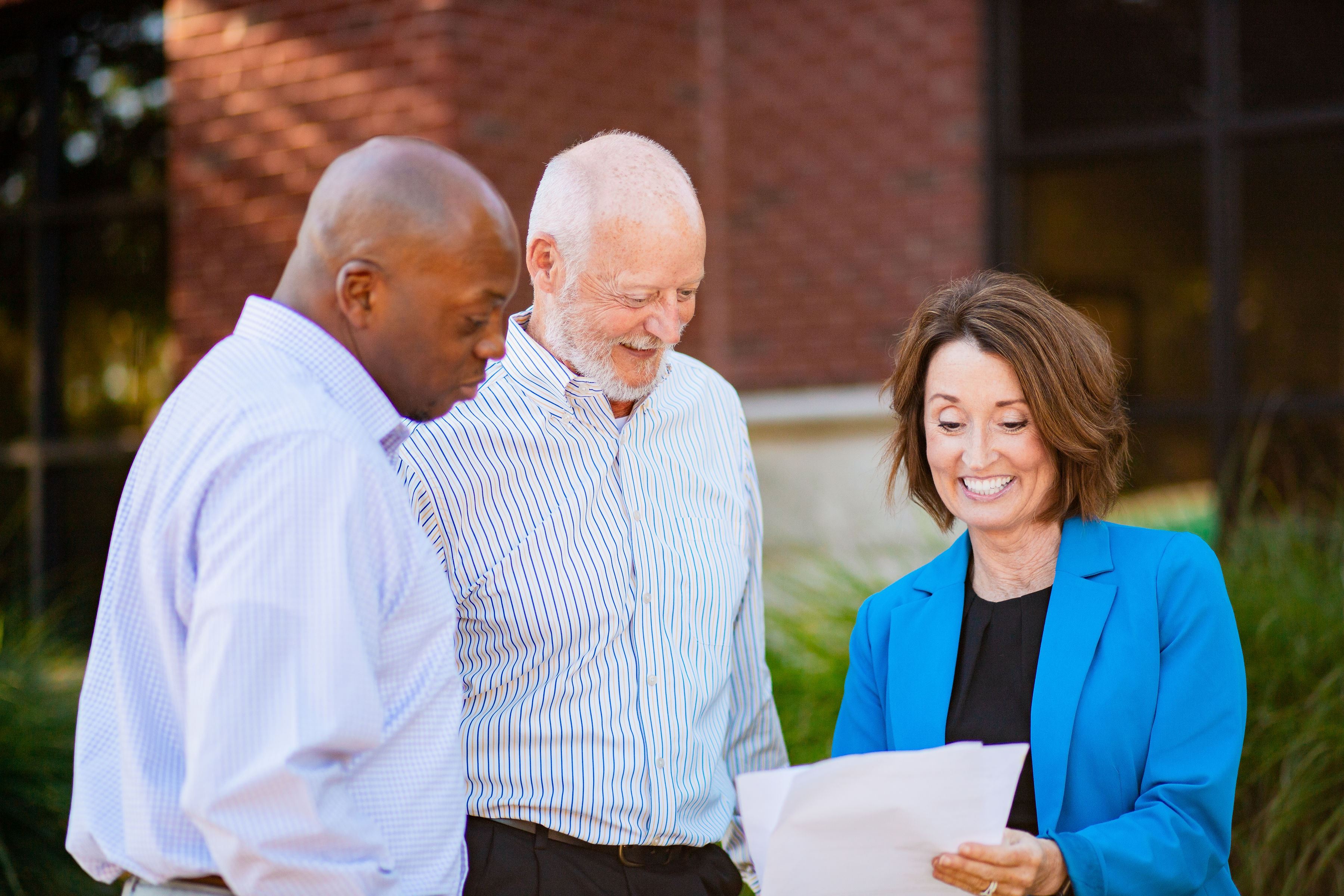 happy people looking at a document