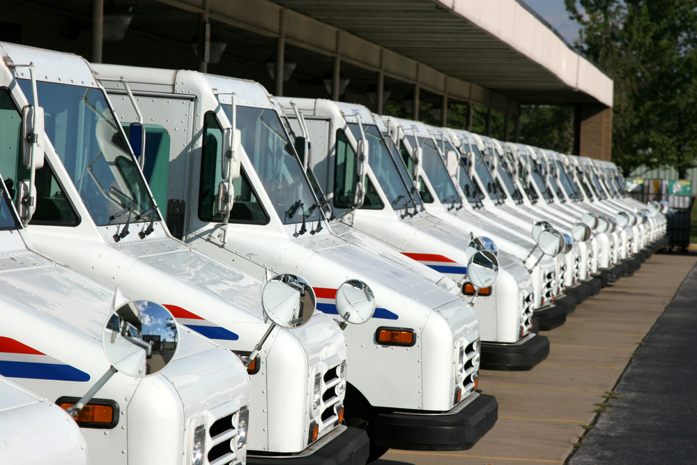 A line of mail trucks gets ready to hit the road.