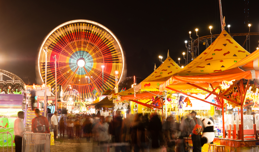 People admire the midway and wonder what to do if they get injured at the North Carolina State Fair.