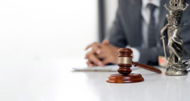 A lawyer sitting by a gavel to symbolize the question of how to file a truck accident claim against UPS.