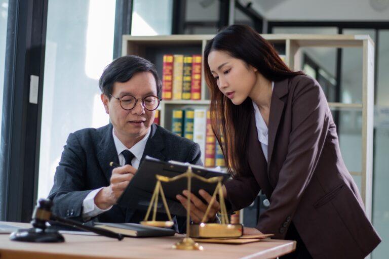 An attorney helps his client understand the answer to her question, “Do I need a lawyer after a motorcycle accident in North Carolina?”
