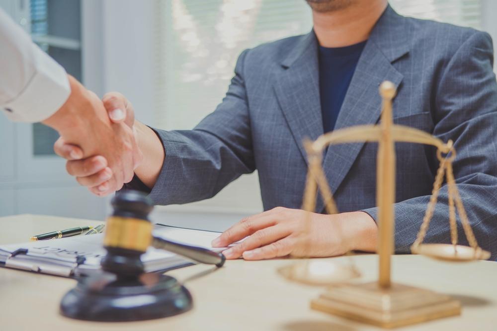 A client shakes hands with an attorney while asking what the personal injury statute of limitations in North Carolina is.
