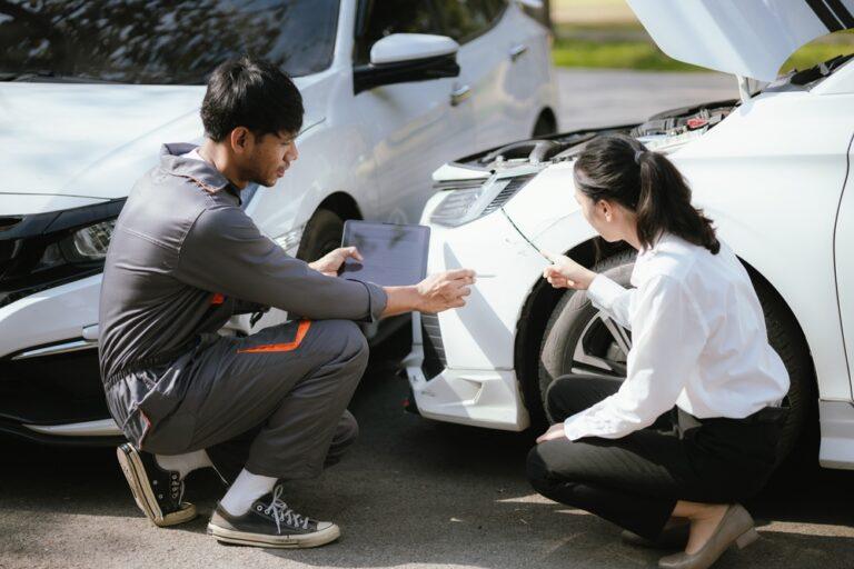 An insurance adjuster reviews vehicle damage with a driver after a crash, a common step in uninsured motorist claims. If you get into an accident with a driver with no coverage, you can turn to your insurance for help.