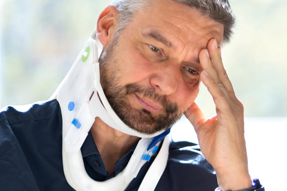 Man dealing with a neck injury and wondering what to do after getting hurt at a sporting event in North Carolina