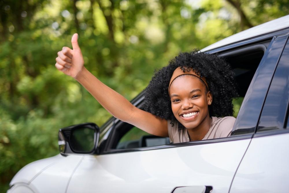 A teenager gives a thumbs up as she drives away, leaving her parents to wonder what to do if their teenager is in a car accident.