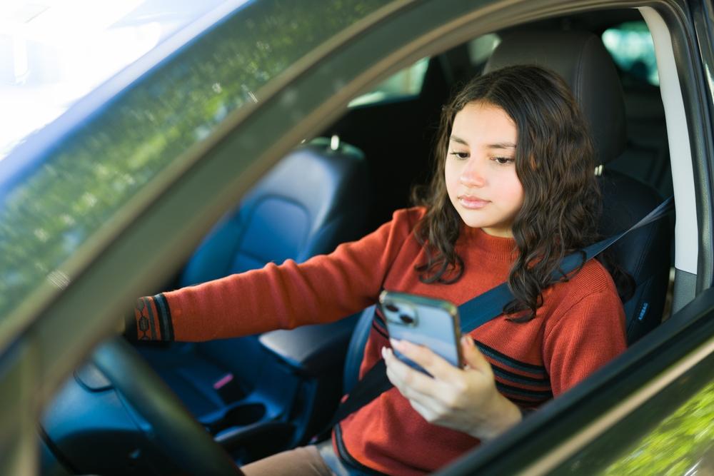 A teenage girl is looking at her phone while driving, which can cause a car accident, and she is wondering whether parents are legally responsible for their teen’s car accident.