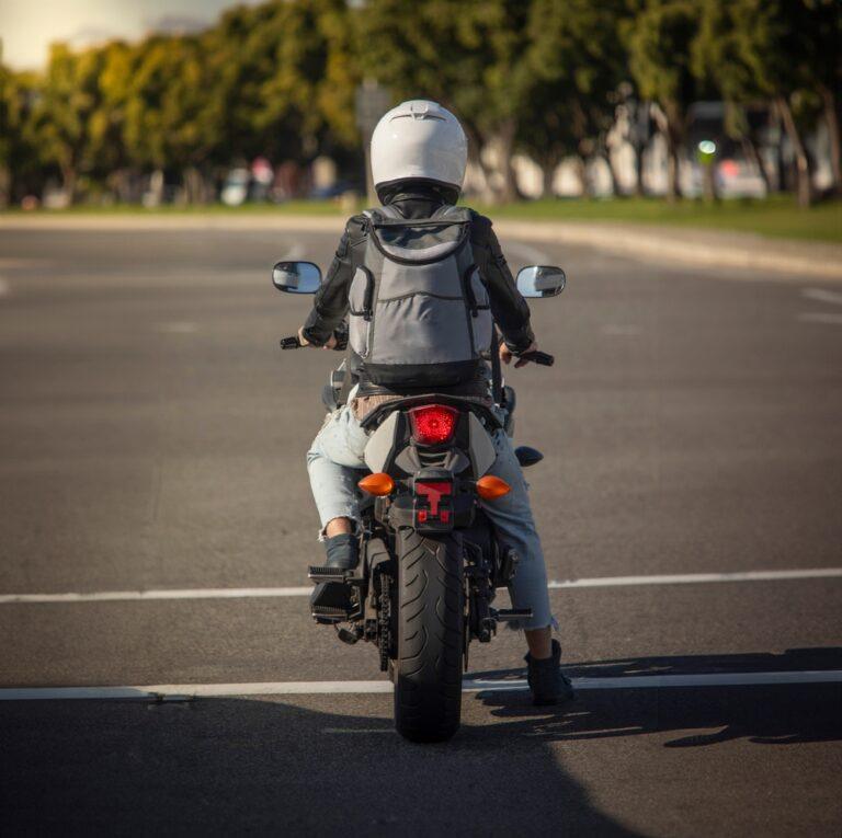 A woman sitting on her motorcycle and wondering if lane-splitting is legal in North Carolina.
