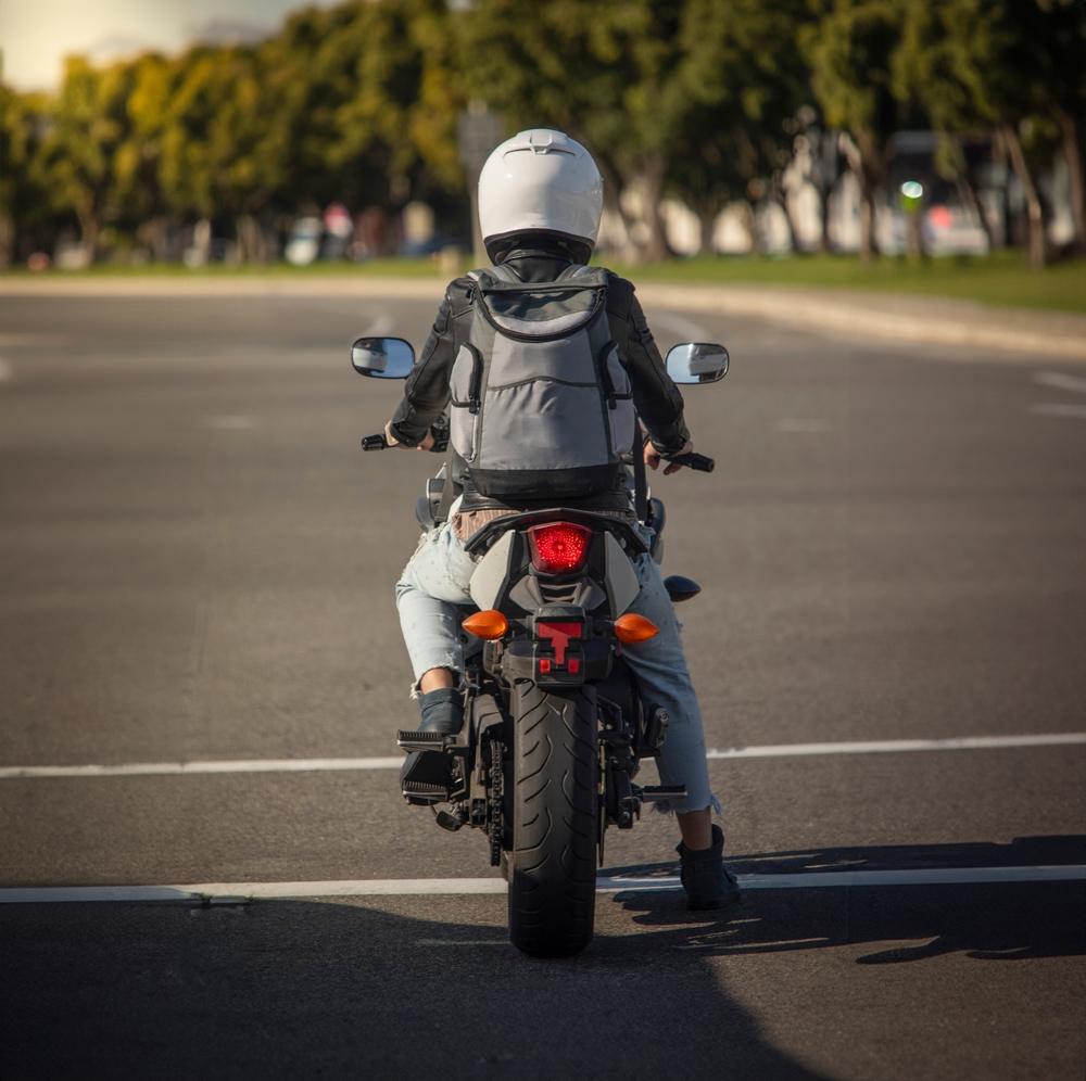 A woman sitting on her motorcycle and wondering if lane-splitting is legal in North Carolina.