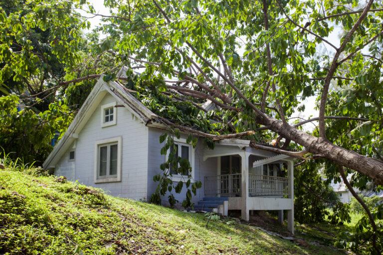 A house with damage that left the owner wondering how to file an insurance claim after a hurricane.